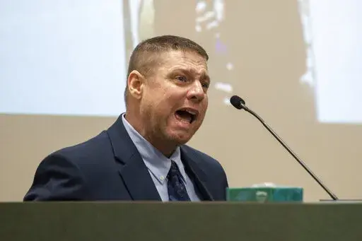 Jacob Blair Scott, who is accused of sexually assaulting a minor, cries out while being cross-examined by Assistant District Attorney Justin Lovorn, during his trial in Jackson County Circuit Court in Pascagoula, Miss., on Wednesday, June 1, 2022. Scott, a military veteran who once faked his own death to try to avoid criminal charges, was convicted Thursday, June 2, 2022,  of sexually assaulting a girl and impregnating her when he was 40 and she was 14.
(Hannah Ruhoff/The Sun Herald via AP)