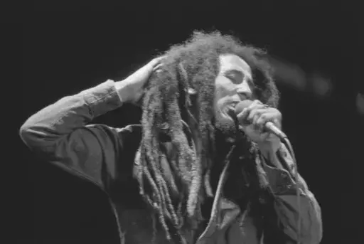 Jamaican Reggae singer Bob Marley performs in front of an audience of 40,000 during a festival concert of Reggae in Paris, France, July 4, 1980. The biopic “Bob Marley: One Love” has been a box office hit in the United States and several other countries. The film, starring Kingsley Ben-Adir, is focused on the Rastafari legend’s story during the making of his 1977 album “Exodus” while leading up to his impactful concert in his native Jamaica. (AP Photo/Jacques Langevin, File)