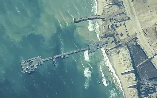 The image provided by U.S, Central Command, shows U.S. Army soldiers assigned to the 7th Transportation Brigade (Expeditionary), U.S. Navy sailors assigned to Amphibious Construction Battalion 1, and Israel Defense Forces placing the Trident Pier on the coast of Gaza Strip on May 16, 2024. (U.S. Central Command via AP, File)