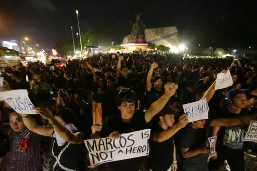  Demonstrators hold slogans as they gather at the People's Power Monument in Quezon city, north of Manila Philippines Friday, Nov. 18, 2016, to protest against the burial of the late dictator Ferdinand Marcos. Filipino   Filipino voters overwhelmingly elected Ferdinand "Bongbong" Marcos Jr., as president during the May 2022 elections, completing a stunning return to power for the family of the late President Ferdinand Marcos, Sr., who ruled the country for more than two decades until being ouste