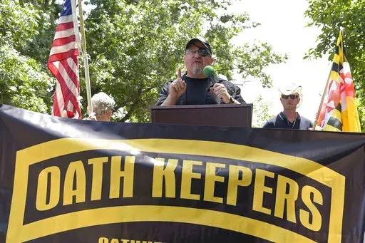 Stewart Rhodes, founder of the Oath Keepers, center, speaks during a rally outside the White House in Washington, June 25, 2017. A new report says that the names of hundreds of U.S. law enforcement officers, elected officials and military members appear on the leaked membership rolls of a far-right extremist group that's accused of playing a key role in the Jan. 6, 2021, riot at the U.S. Capitol. The Anti-Defamation League Center on Extremism pored over more than 38,000 names on leaked Oath Keep
