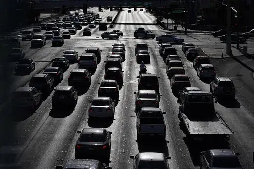 Cars wait at a red light during rush hour, April 22, 2021, in Las Vegas. Motor vehicles with higher, more vertical front ends are the most dangerous to pedestrians, according to a highway safety organization. (AP Photo/John Locher, File)