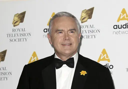 Journalist Huw Edwards poses for photographers upon arrival at the Royal Television Society Programme Awards at the Grosvenor Hotel in London, Tuesday, March 21, 2017. London police say there's no evidence that a BBC presenter who allegedly paid a teenager for sexually explicit photos committed a crime. The Metropolitan police issued the statement Wednesday, July 12, 2023 as the wife of Huw Edwards identified him as the presenter. (AP Photo/Tim Ireland, File)