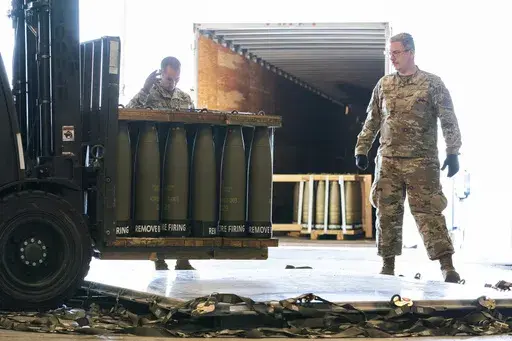 Airmen with the 436th Aerial Port Squadron place 155 mm shells on aircraft pallets ultimately bound for Ukraine, April 29, 2022, at Dover Air Force Base, Del. Half of the people in the U.S. support the Pentagon's ongoing supply of weapons to Ukraine for its defense against Russian forces. That's according to a new survey by the University of Chicago's Harris School of Public Policy and NORC. (AP Photo/Alex Brandon, File)