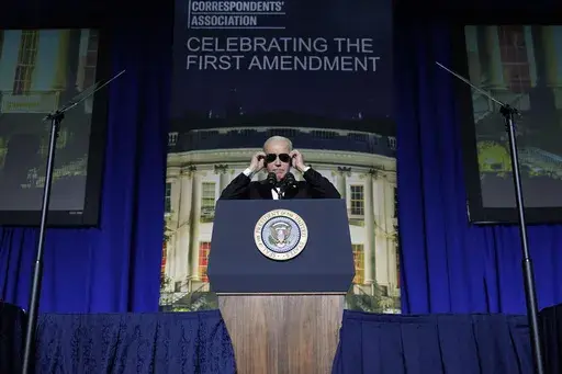 President Joe Biden puts on sunglasses after making a joke about becoming the "Dark Brandon" persona during the White House Correspondents' Association dinner at the Washington Hilton in Washington, April 29, 2023. Both presidential campaigns this year have embraced digital memes, the lingua franca of social media. (AP Photo/Carolyn Kaster, File)