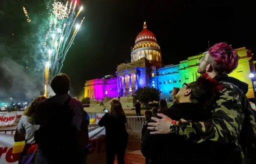 Fireworks shoot into the air next to the Idaho State House, which is illuminated in rainbow colors for the Boise Pride Festival on Friday, Sept. 9, 2022. The event continues through Sunday. (Sarah A. Miller/Idaho Statesman via AP)