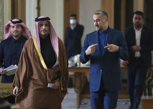 Iranian Foreign Minister Hossein Amirabdollahian, speaks with his Qatari counterpart Sheikh Mohammed bin Abdulrahman Al Thani as they arrive for a joint press briefing, in Tehran, Iran, Sunday, Jan. 29, 2023. (AP Photo/Vahid Salemi)