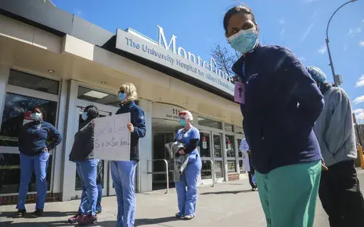 Nurses at Montefiore Medical Center Moses Division hold an "urgent community speak out" and press conference in front of the hospital, demanding N95s and other critical personal protective equipment to handle the COVID-19 outbreak, on April 2, 2020, in New York. Thousands of nurses in New York City notified eight hospitals, including Montefiore, on Friday, Dec. 30, 2022, that they will go on strike in 10 days unless contract agreements are reached. (AP Photo/Bebeto Matthews, File)