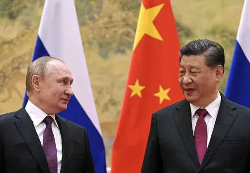 Chinese President Xi Jinping, right, and Russian President Vladimir Putin talk to each other during their meeting in Beijing, China on Feb. 4, 2022. China says President Xi will visit Russia from Monday, March 20, to Wednesday, March 22, 2023, in an apparent show of support for Russian President Putin amid sharpening east-west tensions over the conflict in Ukraine. (Alexei Druzhinin, Sputnik, Kremlin Pool Photo via AP, File)