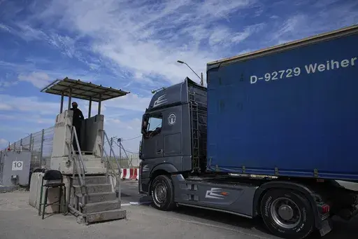 A truck carrying humanitarian aid for the Gaza Strip passes through the Kerem Shalom Crossing in southern Israel, Thursday, March 14, 2024. Under heavy U.S. pressure, Israel has promised to ramp up aid to Gaza dramatically, saying last week it would open another cargo crossing and surge more trucks than ever before into the besieged enclave. But days later, there are few signs of those promises materializing and international officials say famine is fast approaching in hard-hit northern Gaza. (A