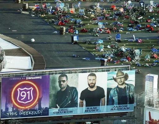 Personal belongings and debris litter the Route 91 Harvest festival grounds across the street from the Mandalay Bay resort and casino in Las Vegas on Oct. 3, 2017, after a mass shooting Oct. 1. A new documentary, “11 Minutes,” is an inside account of the 2017 massacre at a country music concert in Las Vegas. More than three hours long, the four-part documentary debuts on the Paramount+ streaming service Tuesday. (AP Photo/Marcio Jose Sanchez, File)