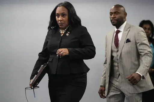 Fulton County District Attorney Fani Willis enteres a room in the Fulton County Government Center ahead of a news conference, Monday, Aug. 14, 2023, in Atlanta. Donald Trump and several allies have been indicted in Georgia over efforts to overturn his 2020 election loss in the state. (AP Photo/John Bazemore)