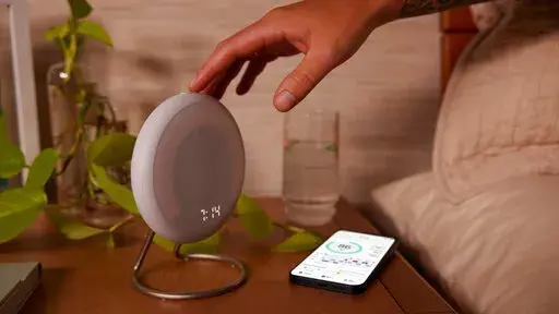 This image provided by Amazon shows the Halo Rise bedside smart alarm. The e-commerce and tech giant said Wednesday, Sept. 28, 2022, that it will start selling the device later this year. Halo Rise will be able to track sleeping patterns without a wristband by using no-contact sensors and artificial intelligence to measure a user’s movement and breathing patterns, according to Amazon. (Amazon via AP)