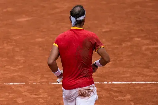 Rafael Nadal of Spain during his match with his teammate Carlos Alcaraz against Tallon Griekspoor and Wesley Koolhof of the Netherlands during the men's doubles tennis competition at the Roland Garros stadium, at the 2024 Summer Olympics, Tuesday, July 30, 2024, in Paris, France. (AP Photo/Manu Fernandez)