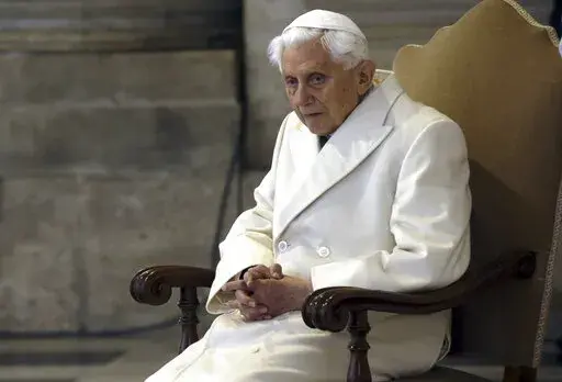 This Dec. 8, 2015 file photo shows Pope Emeritus Benedict XVI sitting in St. Peter's Basilica as he attends the ceremony marking the start of the Holy Year. Retired Pope Benedict XVI asked forgiveness Tuesday, Feb. 8, 2022,  for any “grievous faults" in his handling of clergy sex abuse cases, but admitted to no personal or specific wrongdoing after an independent report criticized his actions in four cases while he was archbishop of Munich, Germany. (AP Photo/Gregorio Borgia)