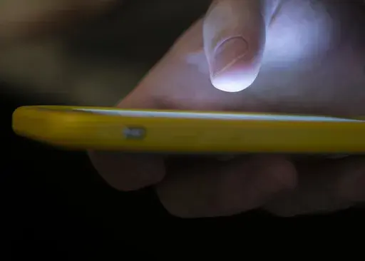 A man uses a cell phone in New Orleans on Aug. 11, 2019. A recent uptick in scams targeting older adults has seniors wondering who’s really calling them. As the most common type of reported Social Security scam, imposters fool beneficiaries into thinking they are providing information to the agency. (AP Photo/Jenny Kane, File)