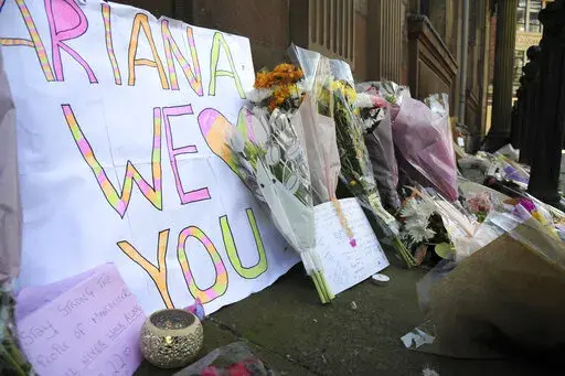 Flower tributes at St Ann's square, Manchester, England, on May 23, 2017, after a suicide bombing attack at an Ariana Grande concert at the Manchester Arena. Britain's domestic intelligence agency didn't act swiftly enough on key information and missed a significant opportunity to prevent the suicide bombing that killed 22 people at a 2017 Ariana Grande concert, an inquiry found Thursday, March 2, 2023. (AP Photo/Rui Vieira, File)