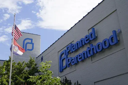 A Missouri and American flag fly outside Planned Parenthood in St. Louis, June 24, 2022. (AP Photo/Jeff Roberson, File)