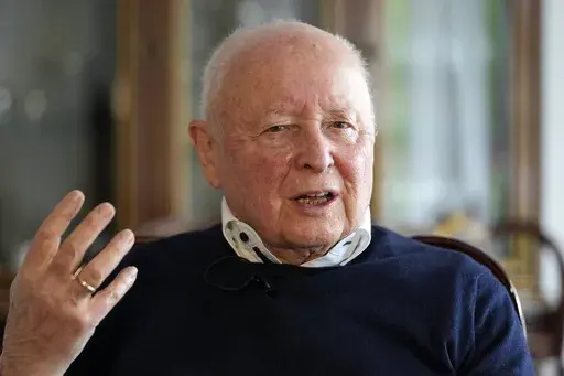 Holocaust survivor Herbert Rubinstein talks during an interview with The Associated Press at his home in Duesseldorf, Germany, Thursday, April 25, 2024. Holocaust survivors from around the globe participating in a new digital campaign called "#CancelHate" which features videos of them reading Holocaust denial posts from different social media platforms. (AP Photo/Martin Meissner)