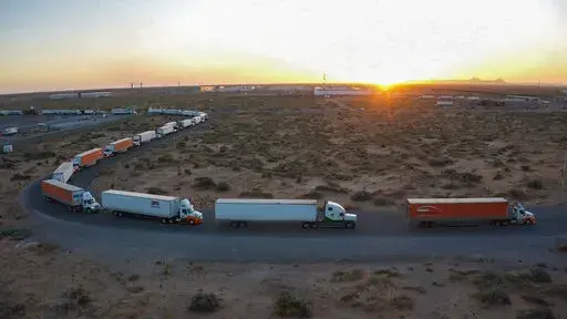 Truckers block the entrance into the Santa Teresa Port of Entry in Ciudad Juarez going into New Mexico on April 12, 2022. The truckers blocked the port as a protest to the prolonged processing times implemented by Gov. Abbott which they say have increased from 2-3 hours up to 14 hours in the last few days. (Omar Ornelas /The El Paso Times via AP)