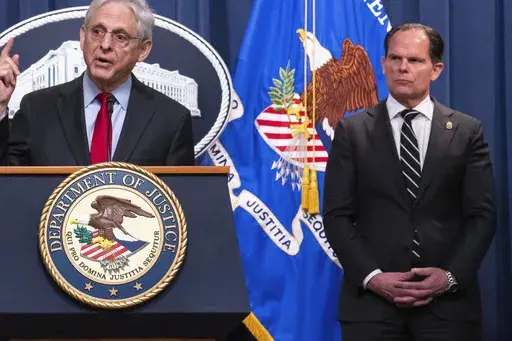 DEA Principal Deputy Administrator Louis Milione, right, stands behind Attorney General Merrick Garland during the announcement of an international law enforcement operation targeting fentanyl and opioid traffickers on the Darknet during a news conference at the Department of Justice, Tuesday, May 2, 2023, in Washington. In September 2023, Milione, the U.S. Drug Enforcement Administration’s recently departed second-in-command returned for a new stint with Guidepost Solutions, the high-powered 