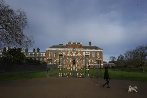 A dog walker passes Kensington Palace in London, Friday, Jan. 6, 2023. The first official photo of Kate, the Princess of Wales, since she underwent abdominal surgery nearly two months earlier, was pulled from circulation by The Associated Press and several other news organizations, Sunday, March 10, 2024, because the image appeared to have been manipulated. (AP Photo/Kirsty Wigglesworth, File)