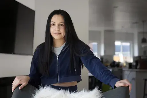 Cassandra Nuñez poses for a portrait at home Thursday, May 11, 2023, in Inglewood, Calif. Nuñez and her grandmother cast their first ballots in a U.S. presidential election in 2016. She was a first-year college student; her grandmother, a newly minted citizen. (AP Photo/Marcio Jose Sanchez)
