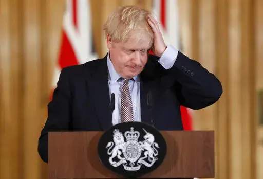 Britain's Prime Minister Boris Johnson reacts during a press conference at Downing Street on the government's coronavirus action plan in London Tuesday, March 3, 2020. (AP Photo/Frank Augstein, File)