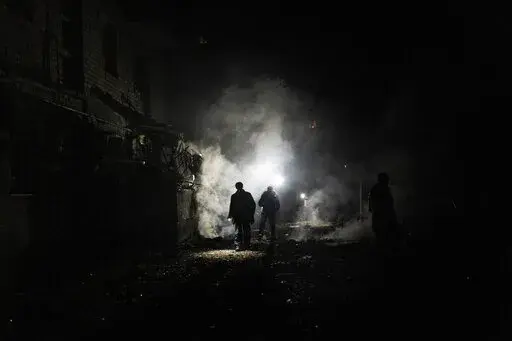 Resident walks amid debris after a Russian attack in Kherson, southern Ukraine, Nov. 24, 2022. In a deliberate, widespread campaign, Russian forces systematically targeted influential Ukrainians, nationally and locally, to neutralize resistance through detention, torture and executions, an Associated Press investigation has found. (AP Photo/Bernat Armangue, File)