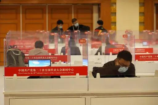 Chinese journalists work at a press center for the 20th Party Congress in Beijing on  Oct. 20, 2022. China's ruling Communist Party has long relied on a critically important and secretive internal reference system to learn about issues considered too sensitive for the public to know. But as Chinese leader Xi Jinping tightens censorship and consolidates his rule, Chinese academics and journalists say even this internal system is struggling to give frank assessments. (AP Photo/Ng Han Guan)