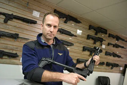 Adrian Kellgren, director of industrial production of KelTec, holds a 9mm SUB2000 rifle, similar to ones being shipped to Ukraine, at their manufacturing facility on Thursday, March 17, 2022, in Cocoa, Fla. Kellgren’s family-owned gun company was left holding a $200,000 shipment of semi-automatic rifles after a longtime customer in Odessa suddenly went silent during Vladimir Putin’s invasion of Ukraine. Fearing the worst, the company decided to put those stranded 400 guns to good use, sendin