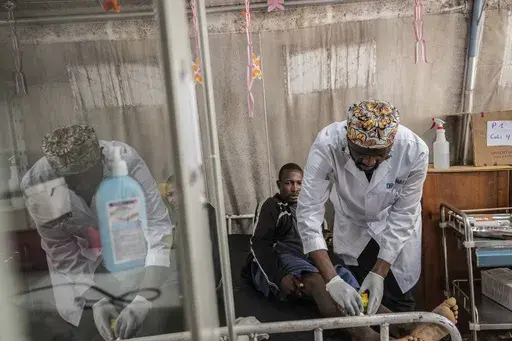 Medics treat a man wounded during fighting between Congolese government troops and M23 rebel forces in Goma's Kyeshero hospital Saturday, Feb. 1, 2025. (AP Photo/Moses Sawasawa)