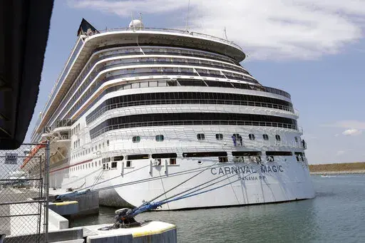 The Carnival cruise line ship Carnival Magic sits docked on April, 2020, in Cape Canaveral, Fla. A crew was dispatched early Thursday, May 26, 2022, to the ship, which is now docked in Norfolk, Virginia, to investigate a chemical smell and passengers feeling ill according to a report the Coast Guard received. (AP Photo/John Raoux, File)