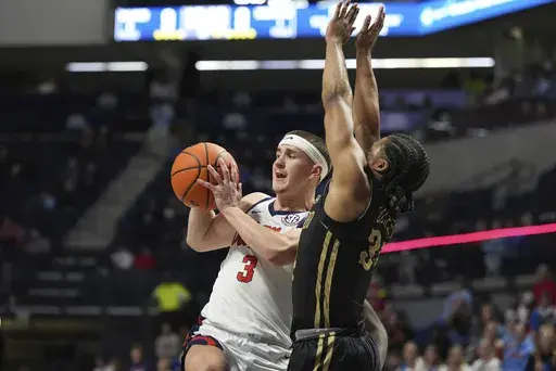 Mississippi guard Sean Pedulla (3) passes off while defended by Lindenwood guard Clayton Jackson (34) during the first half of an NCAA college basketball game, Saturday, Dec. 7, 2024, in Oxford, Miss. (AP Photo/Rogelio V. Solis)