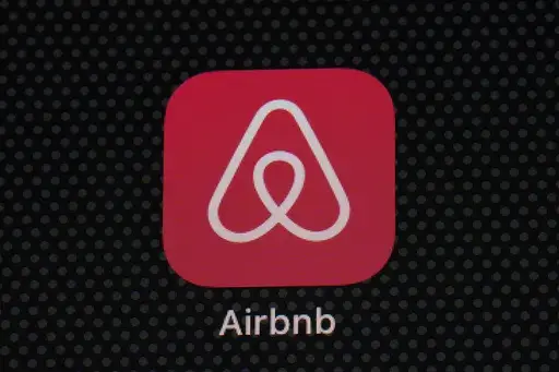 The Airbnb app icon is displayed on an iPad screen in Washington, D.C., on May 8, 2021. Airbnb says it’s banning the use of indoor security cameras in listings around the world by the end of next month. The San Francisco-based online rental platform said it making the change to simplify its security camera policy and continue efforts to prioritize privacy. (AP Photo/Patrick Semansky, File)