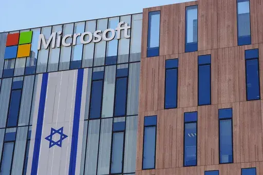 An Israeli flag is draped over the Microsoft offices in a building in the Gav Yam technology park in Beersheba, Israel, on Thursday, May 30, 2024. (AP Photo/Sam Mednick)
