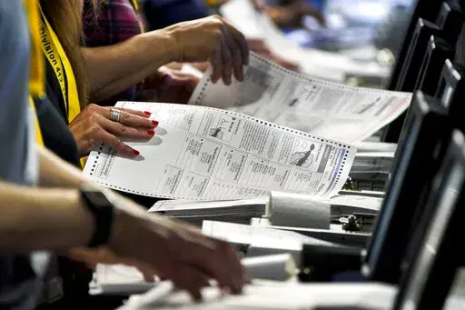 Election workers perform a recount of ballots from the recent Pennsylvania primary election at the Allegheny County Election Division warehouse on the Northside of Pittsburgh, June 1, 2022. Unlike in many other countries, elections in the U.S. are highly decentralized, complex and feature a long list of races on the ballot, from president or Congress all the way down to local ballot measures or town council seats. Rules also vary greatly by state. Some give local election offices several weeks b