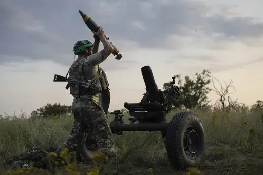 A Ukrainian serviceman of the 3rd Assault Brigade fires a 122mm mortar towards Russian positions at the front line, near Bakhmut, Donetsk region, Ukraine, Sunday, July 2, 2023. Employees from a Ukrainian arms firm conspired with defense ministry officials to embezzle almost $40 million earmarked to buy 100,000 mortar shells for the war with Russia, Ukraine's security service reported. The SBU said late Saturday, Jan. 27, 2024 that five people have been charged and the money has been recovered. (
