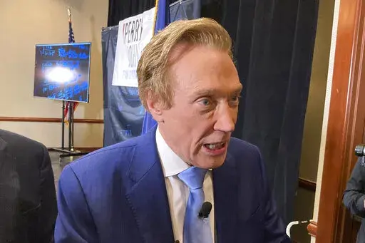 Michigan gubernatorial candidate Perry Johnson, a Republican, briefly speaks with reporters, on Feb. 23, 2022, after a kickoff event at a hotel in Lansing, Mich. Johnson lost a bid to get on the Aug. 2 primary ballot Wednesday, June 1, 2022, in the first key court decision since election officials found campaign petitions rife with fraudulent signatures.(AP Photo/David Eggert, File)