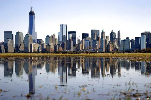 New York's Lower Manhattan skyline, including the One World Trade Center, left, is reflected in water on April 6, 2013, as seen from Liberty State Park in Jersey City, N.J. Eight of the 10 largest cities in the U.S. lost population during the first year of the pandemic, with only Phoenix and San Antonio gaining new residents from 2020 to 2021, according to new estimates released, Thursday, May 26, 2022, by the U.S. Census Bureau. (AP Photo/Mel Evans, File)