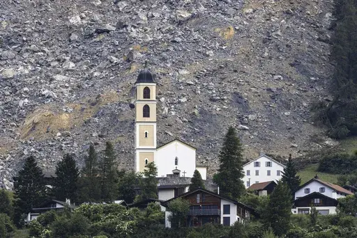 General view of part of the village of Brienz-Brinzauls below the rockfall "Brienzer Rutsch", in Switzerland, Friday, June 16, 2023. On Thursday night, a large part of the rock masses fell towards the village. The rock masses just missed the village and left behind a meter-high deposit on the main road near the school building. No one was injured since the village was evacuated on May 12. (Michael Buholzer/Keystone via AP)