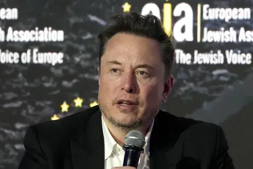 Elon Musk addresses the European Jewish Association's conference, in Krakow, Poland, Monday, Jan. 22, 2024. Musk is suing OpenAI and its CEO Sam Altman, Thursday, Feb. 29, over what he says is a betrayal of the ChatGPT maker's founding aims of benefiting humanity rather than pursuing profits. (AP Photo/Czarek Sokolowski, File)