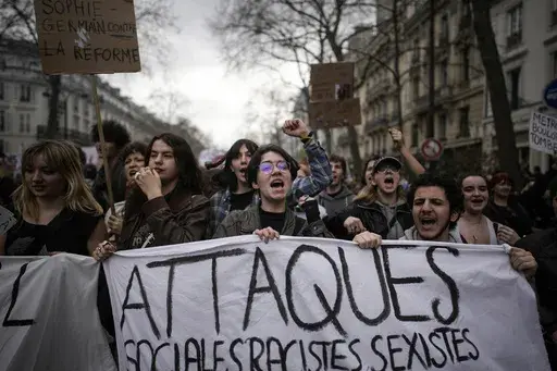 Protesters march during a rally in Paris, on March 23, 2023. French President Emmanuel Macron has ignited a firestorm of anger with unpopular pension reforms that he rammed through parliament. Young people, some of them first-time demonstrators, are joining protests against him. Violence is also picking up. (AP Photo/Christophe Ena, File)