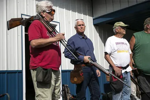 Former Vice President and current 2024 Republican presidential candidate Mike Pence receives safety instructions before his turn to shoot during the 10th annual Jasper County GOP trap shoot on Saturday, Sept. 16, 2023, at Jasper County Gun Club in Newton, Iowa. Four Republican presidential hopefuls, made a campaign stop at the event to speak with constituents and shoot a few rounds. (Geoff Stellfox/The Gazette via AP)