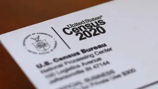 An envelope containing a 2020 census letter mailed to a U.S. resident sits on a desk on on April 5, 2020, in Detroit. A coding error in an annual survey by the U.S. Census Bureau has offered unprecedented insight into how large numbers of Brazilians in the U.S. identify as Hispanic. (AP Photo/Paul Sancya, File)