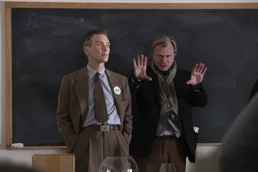 This image released by Universal Pictures shows writer-director-producer Christopher Nolan, right, and actor Cillian Murphy on the set of "Oppenheimer." (Melinda Sue Gordon/Universal Pictures via AP)