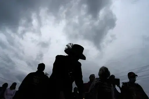 People attend a dedication of a prayer wall outside of the historic Vernon African Methodist Episcopal Church in the Greenwood neighborhood during the centennial of the Tulsa Race Massacre, in Tulsa, Okla., May 31, 2021. (AP Photo/John Locher, File)