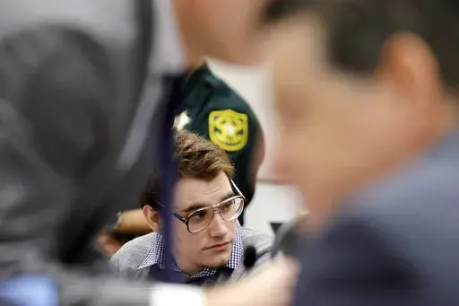 Marjory Stoneman Douglas High School shooter Nikolas Cruz is shown at the defense table during the penalty phase of Cruz's trial at the Broward County Courthouse in Fort Lauderdale, Fla., on Monday, Sept. 12, 2022. Cruz pleaded guilty to murdering 17 students and staff members in 2018 at Parkland's high school. The trial is only to determine if the 23-year-old is sentenced to death or life without parole. (Amy Beth Bennett/South Florida Sun-Sentinel via AP, Pool)