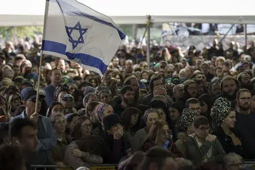 Mourners attend the funeral of Israeli staff sergeant Elisha Yehonatan Lober, who was killed in battle in the Gaza Strip, at the Mount Herzl military cemetery in Jerusalem, Israel, Wednesday, Dec. 27, 2023. (AP Photo/Leo Correa)