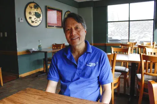 Charles Yee sits in his restaurant, Emperor's Kitchen, in Brookfield, Wis, on Feb. 23, 2022. He says while the Russian invasion of Ukraine is on his mind his priorities lie in his daily battle with the supply-chain problems, inflation and staffing shortages that continue to cling to the economy. Yee's view echoes in this western Milwaukee suburb, a politically dynamic swath of one of the nation's most evenly divided states. (AP Photo/Carrie Antlfinger)